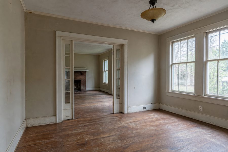 Before deep house restoration showing worn floors dated walls damaged trim old fixtures and aged windows for Cerpa Construction LLC.