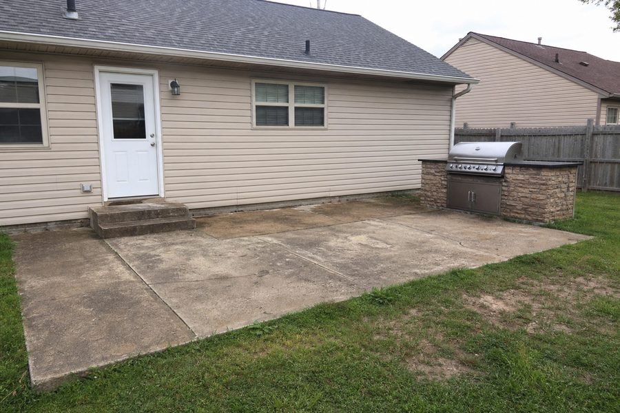 Before exterior patio renovation showing cracked concrete outdated grill area worn steps and backyard space for Cerpa Construction LLC.