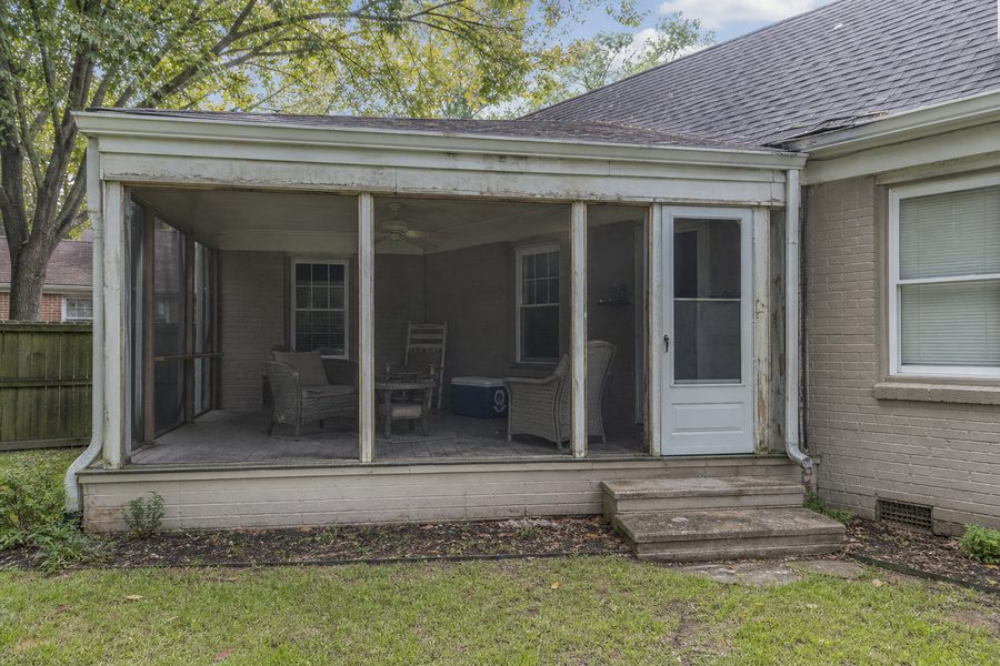 Before screened porch renovation showing worn screens old trim dated flooring and exterior porch area for Cerpa Construction LLC.